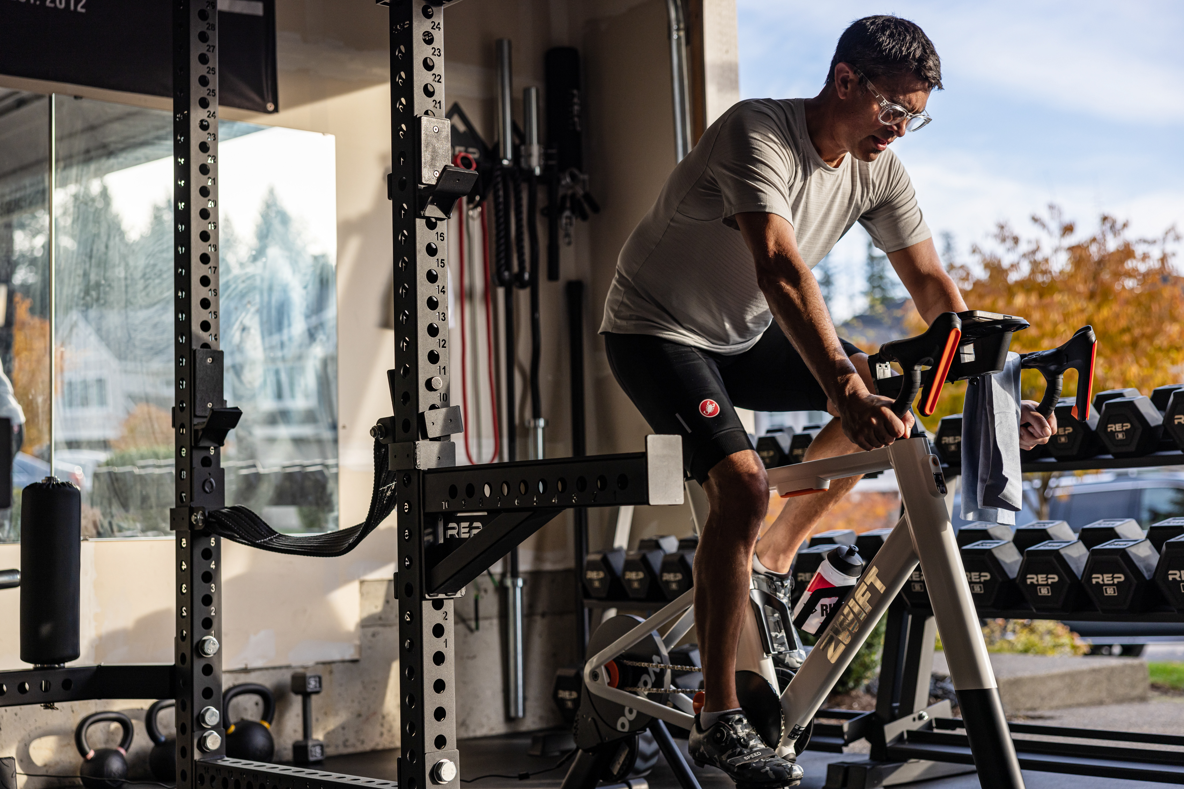 Man on stationary bike in garage gym