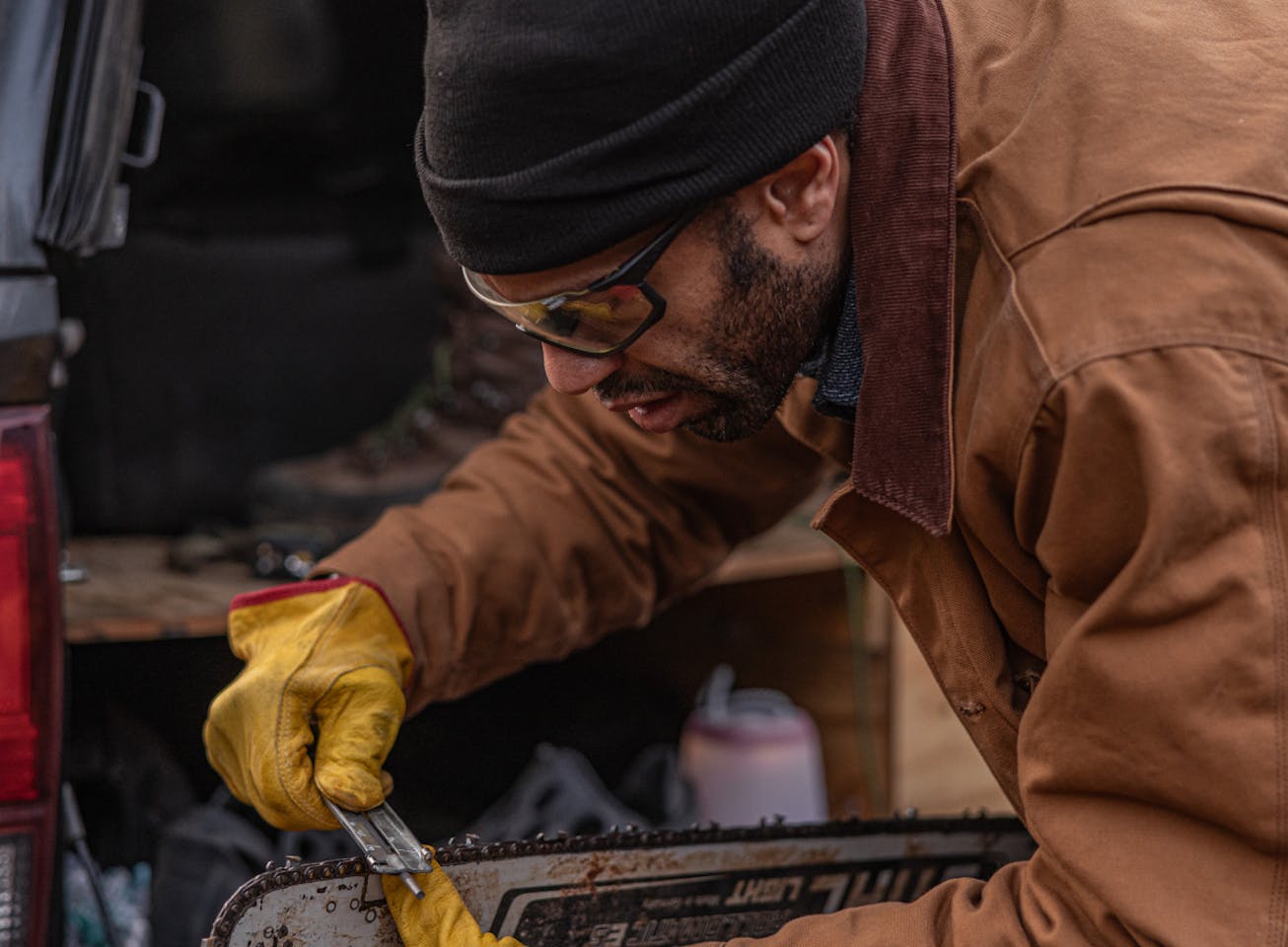Man with chainsaw and GP-1xt sunglasses