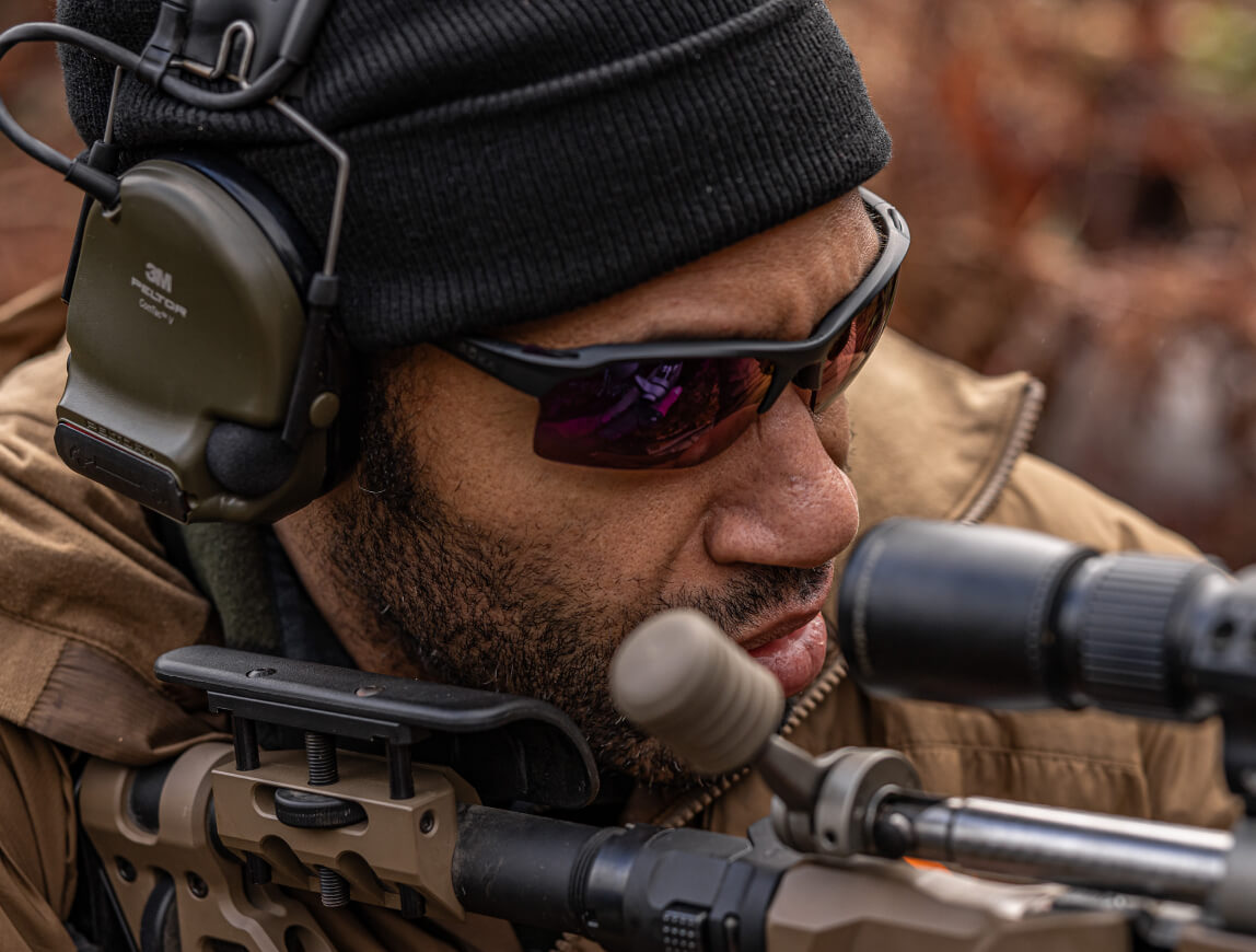 Man Looking through scope in tl-1 sunglasses