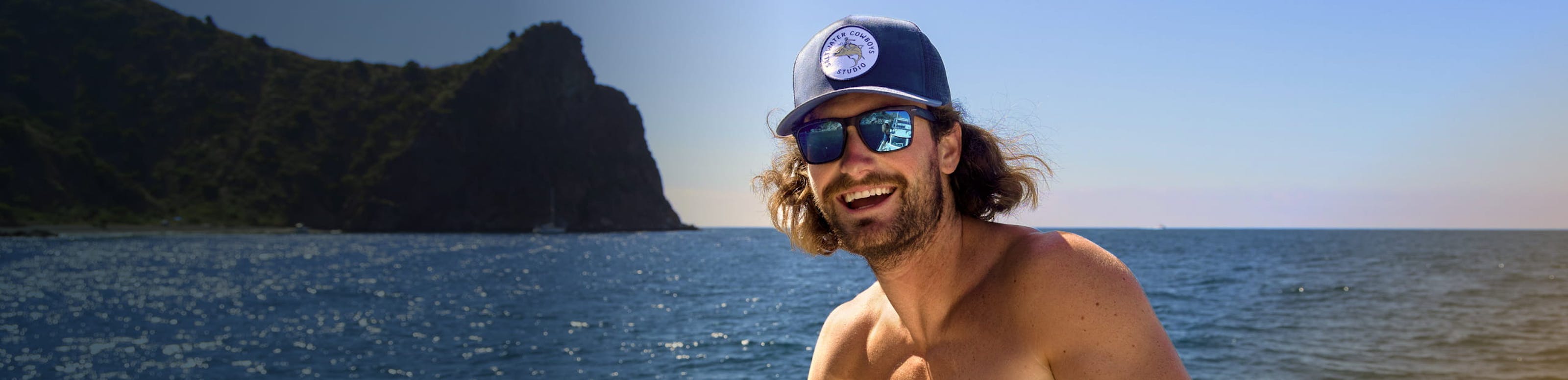 Man smiling on lake with ROKA sunglasses