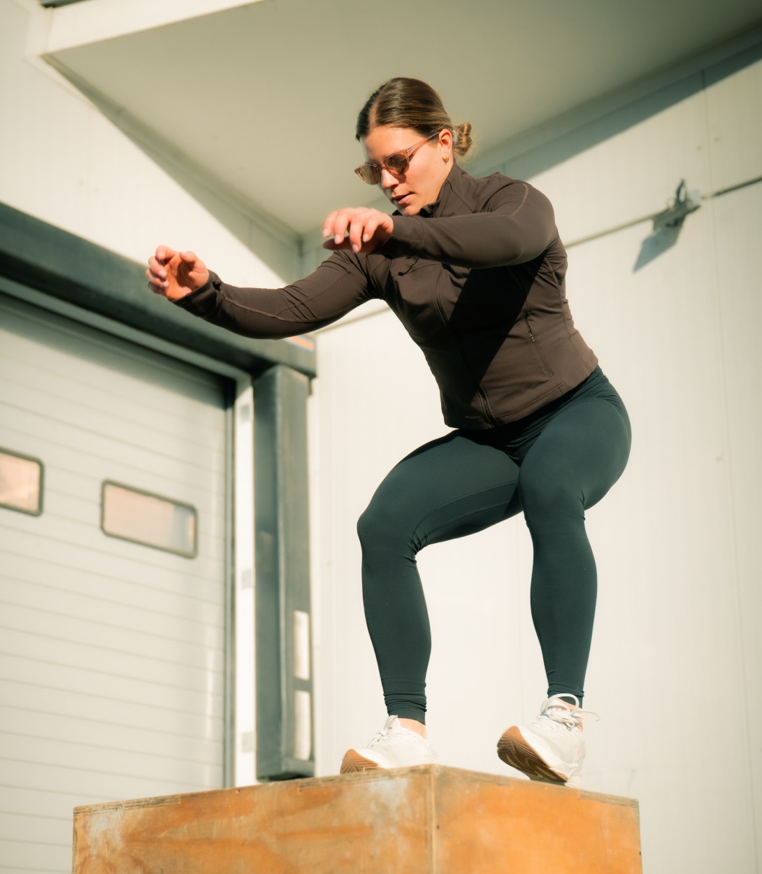 Woman box jumping in Lola sunglasses