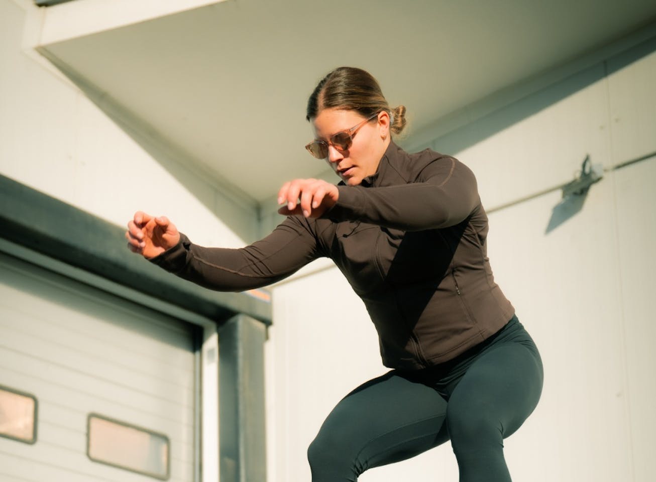 Woman box jumping in Lola sunglasses