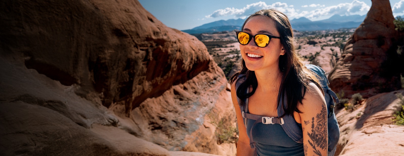 Woman smiling in canyon with gold Lola sunglasses