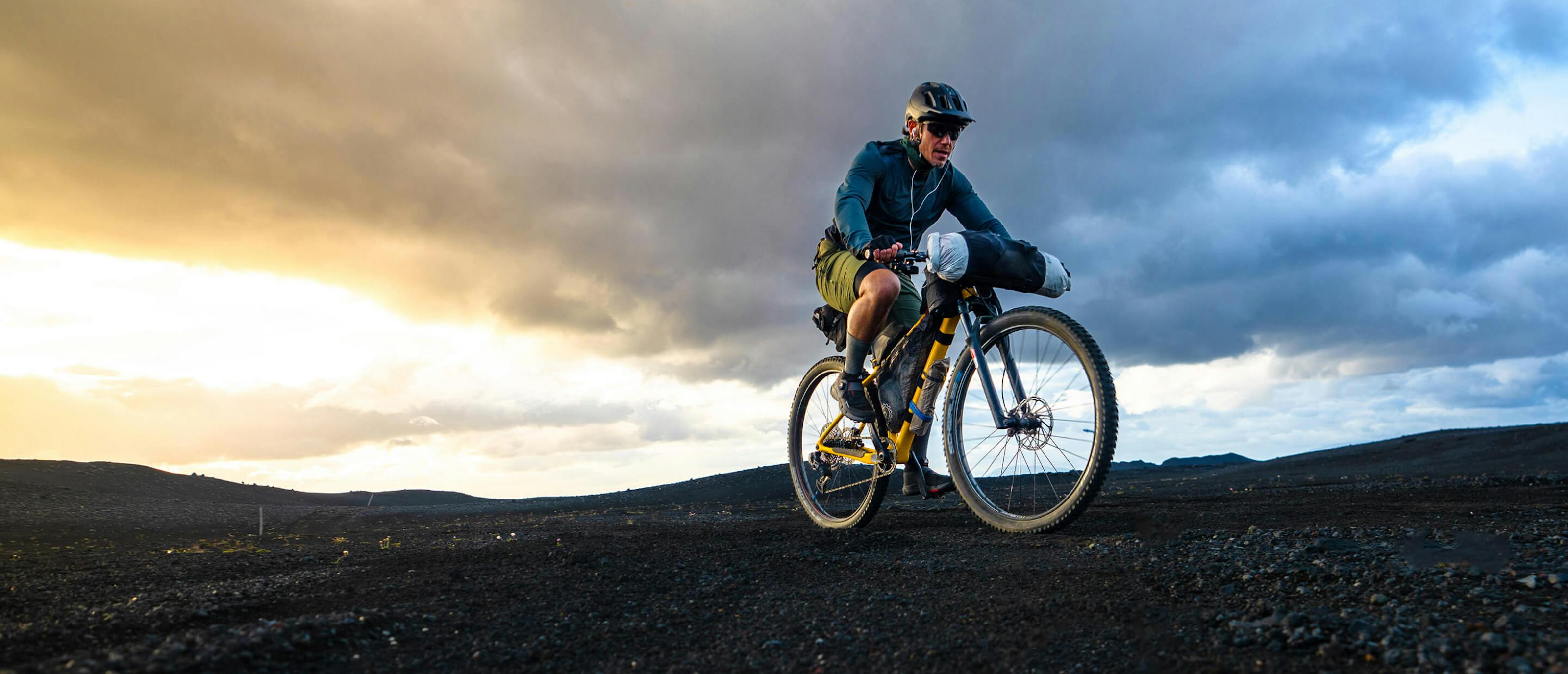 Chris burkard on bike with sunset in background