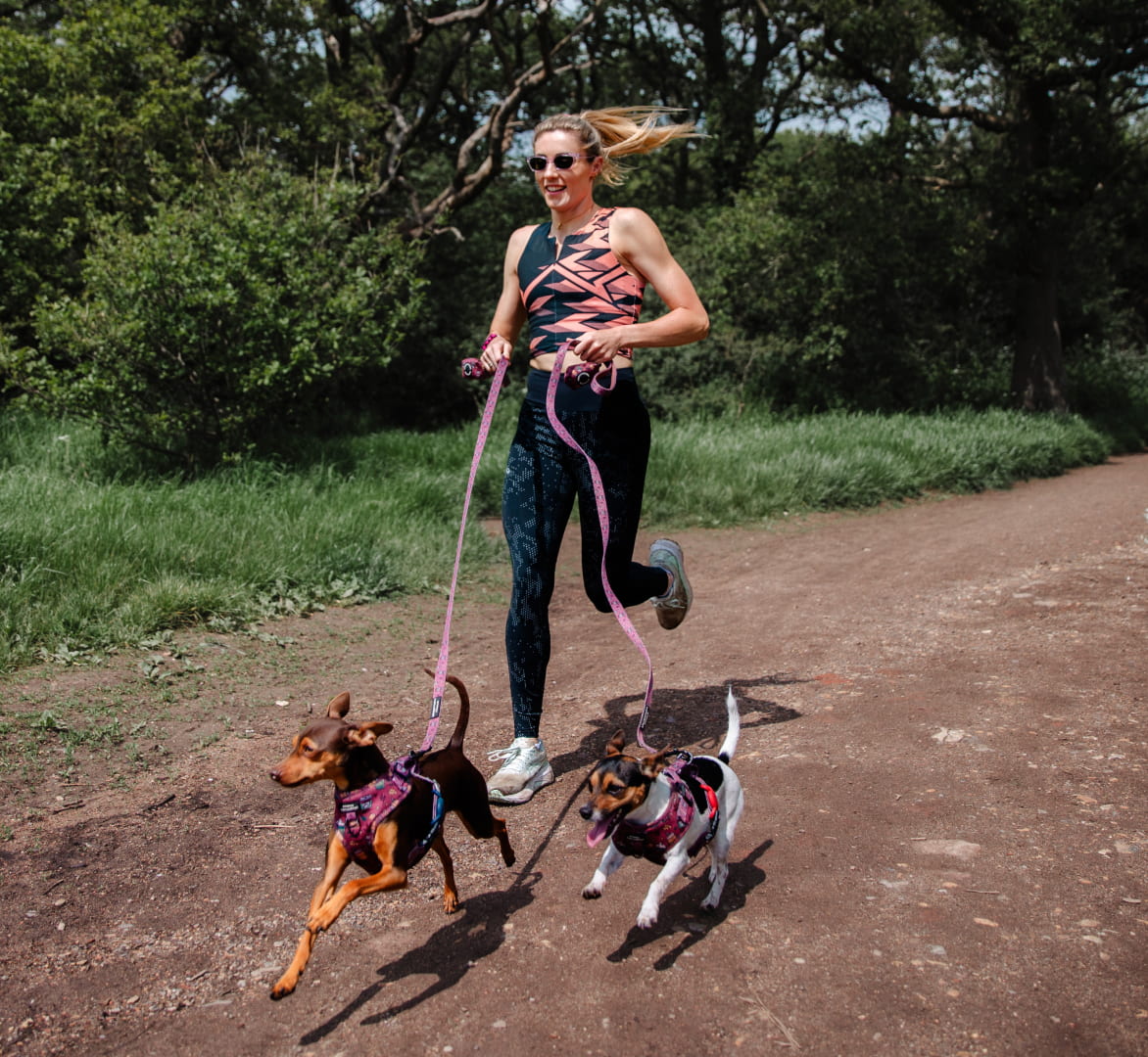 Woman running with dogs wearing Siena sunglasses