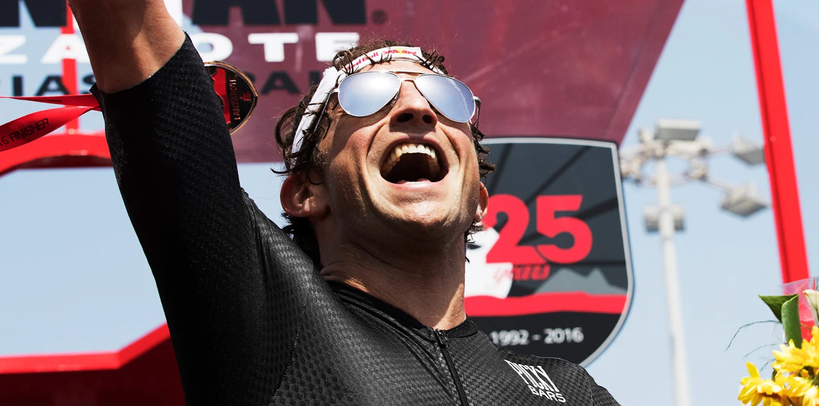 Man celebrating a win wearing ROKA aviator sunglasses