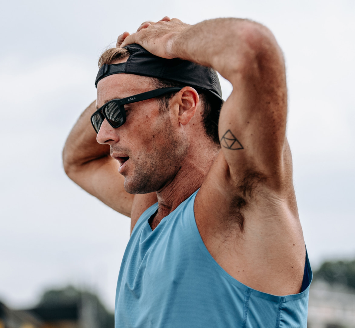 Man with hands over head in Estacado sunglasses