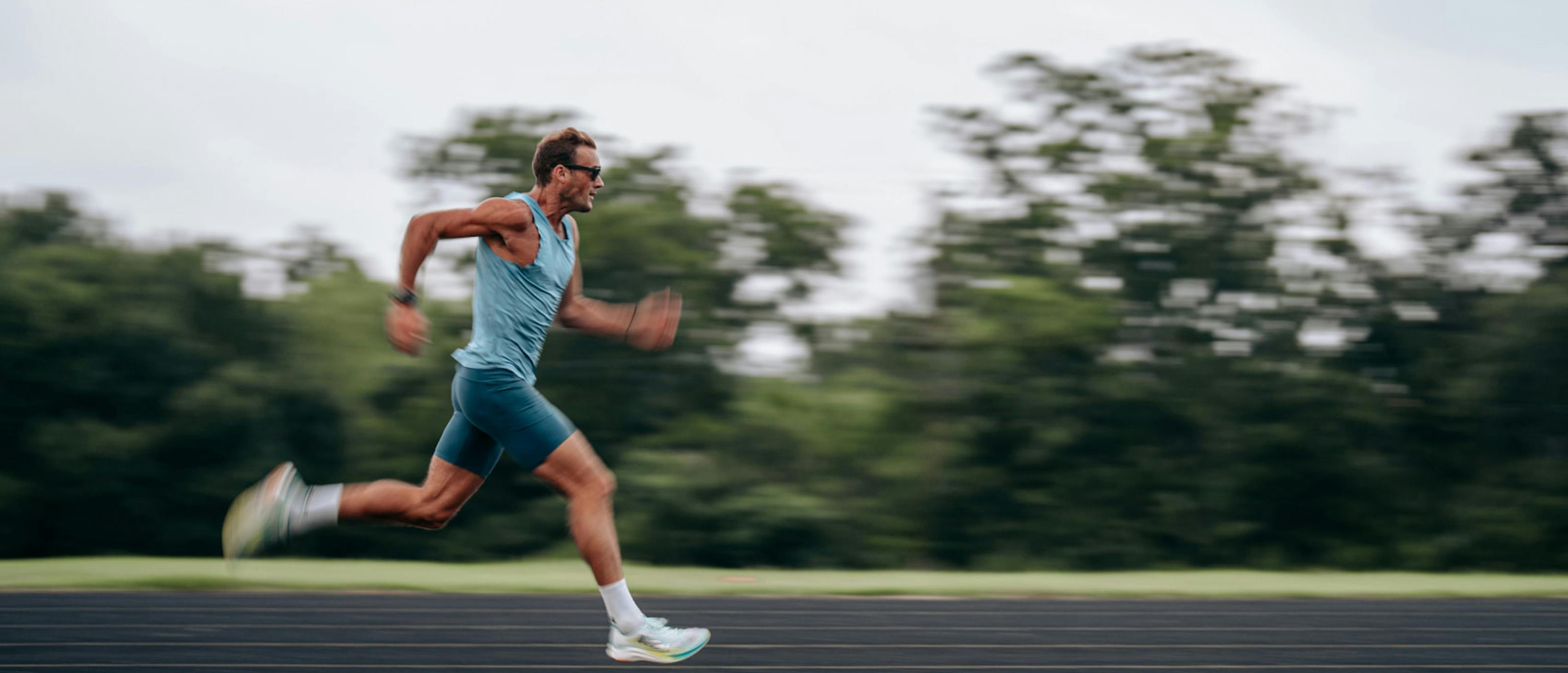 Man running on track wearing Estacado sunglasses