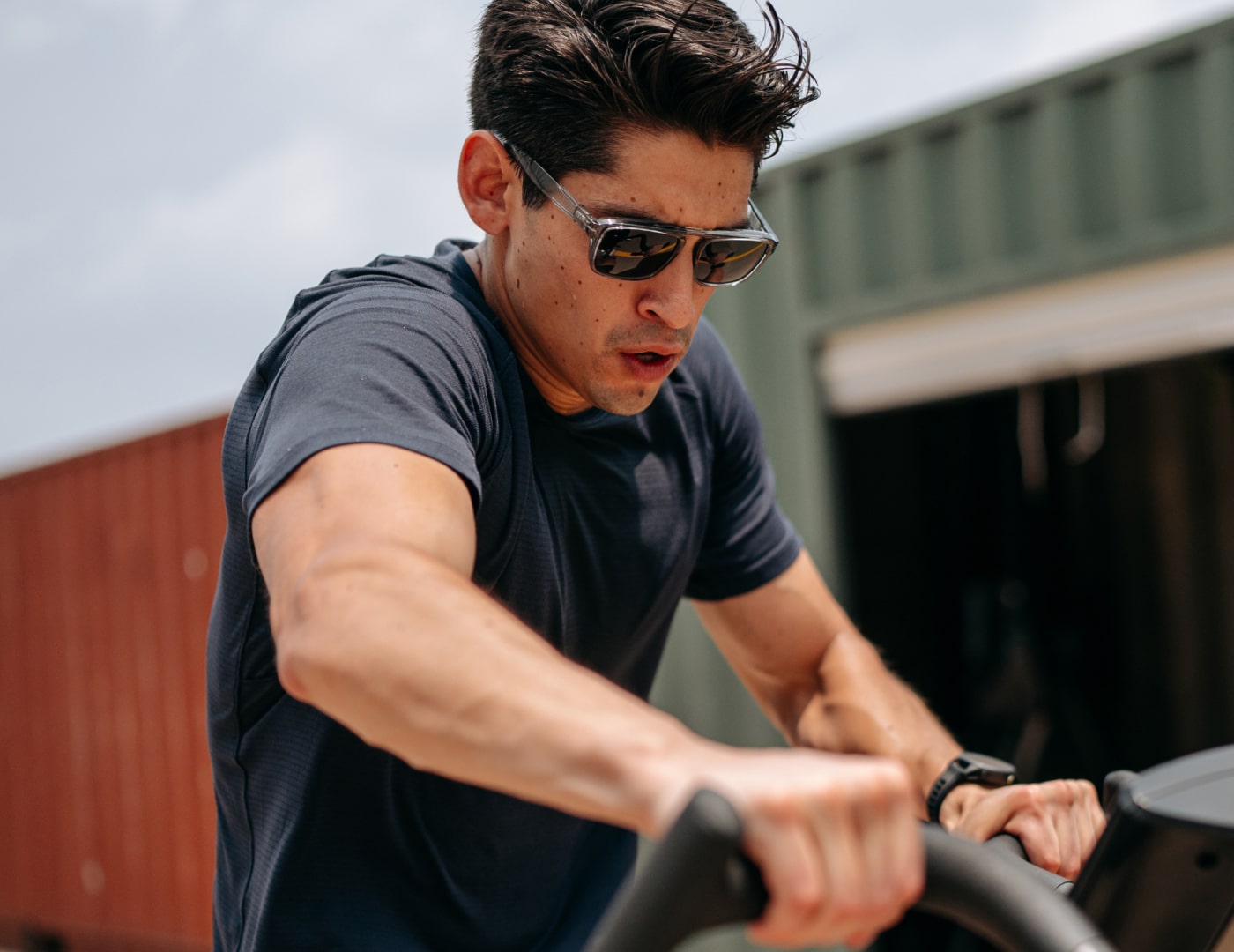 Man riding airbike wearing Estacado sunglasses