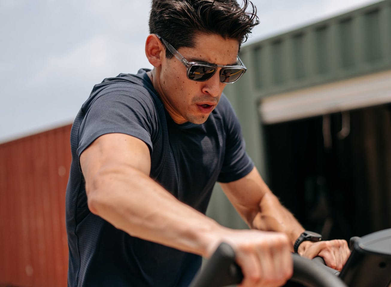 Man riding airbike wearing Estacado sunglasses