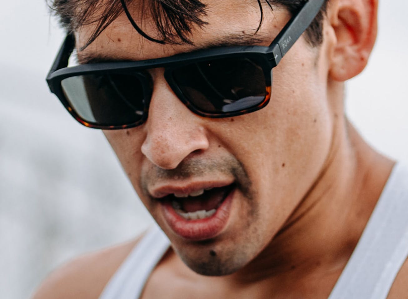 Man looking down wearing Estacado sunglasses