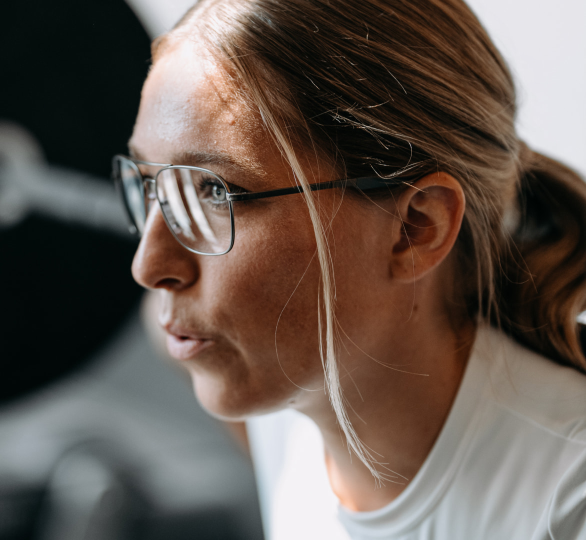 Woman in gym wearing Falcon Titanium eyeglasses