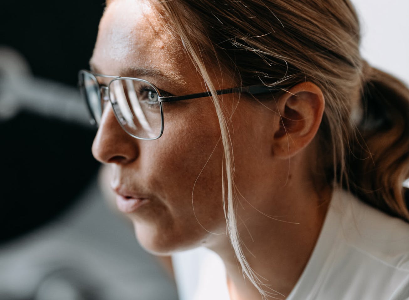 Woman in gym wearing Falcon Titanium eyeglasses