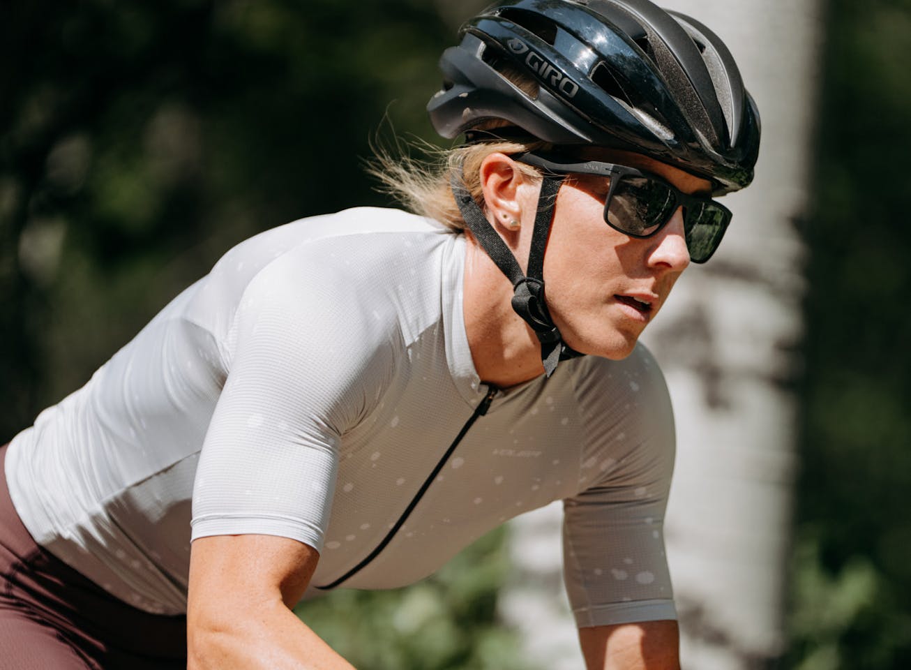 Woman cycling wearing Barton sunglasses