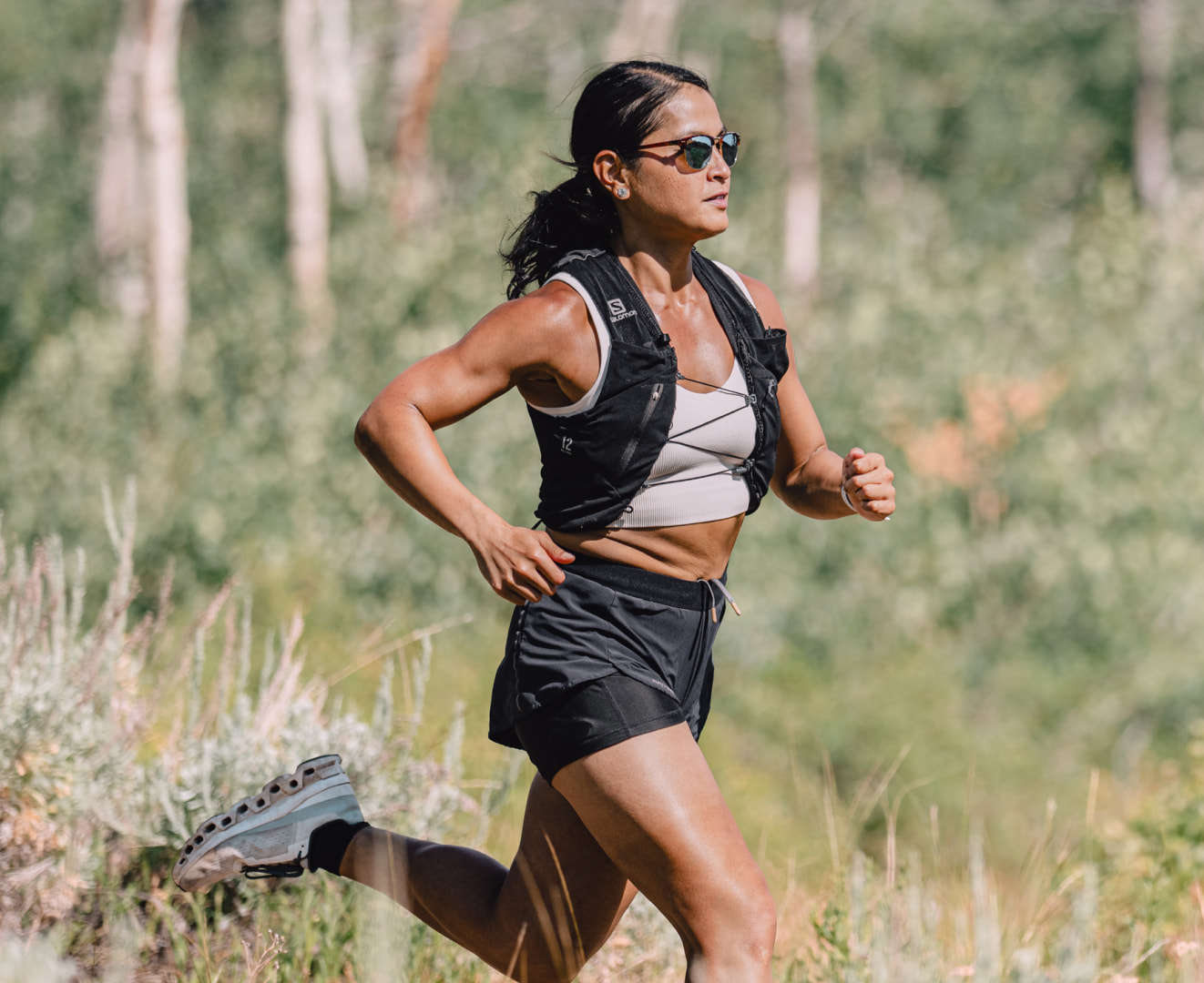 Woman trail running wearing Cambridge sunglasses
