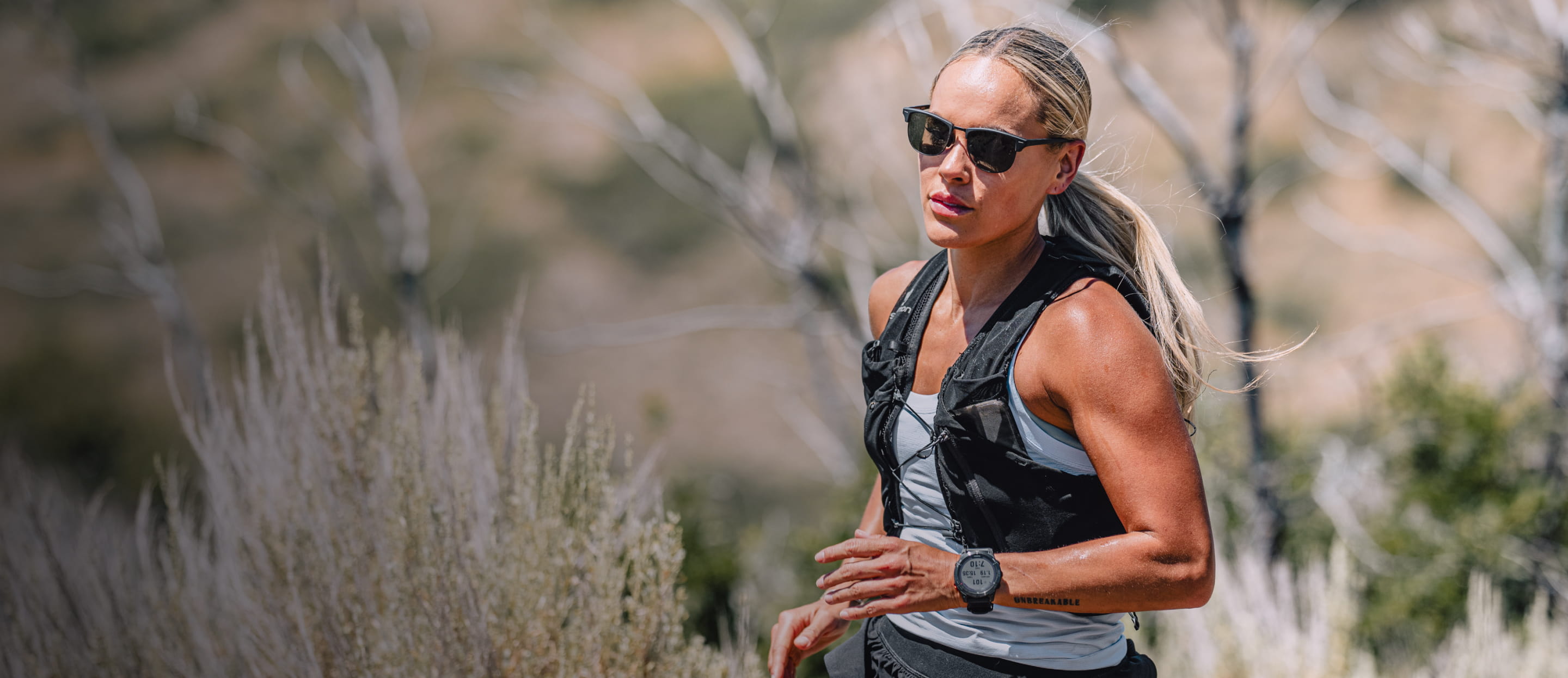 Woman trail running wearing Cambridge sunglasses