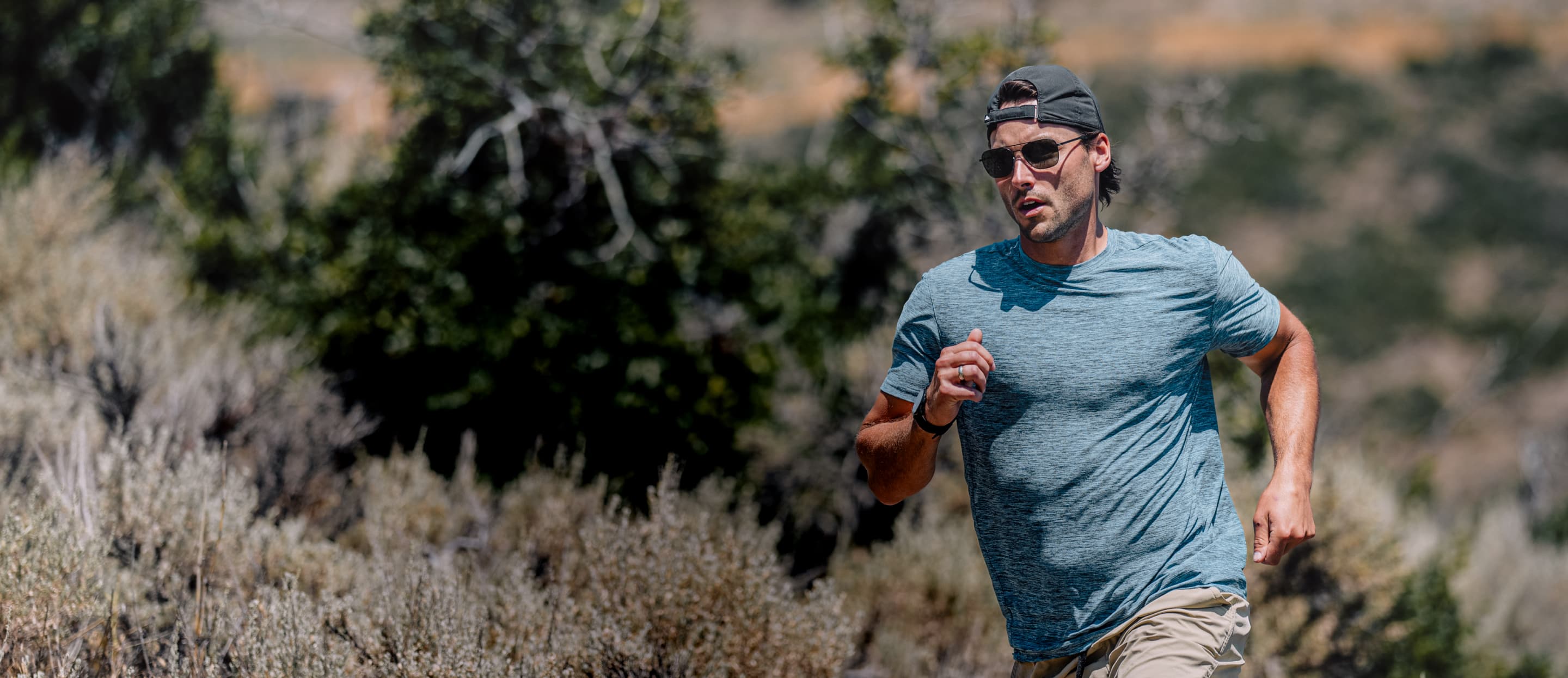 Man running outside wearing Falcon sunglasses