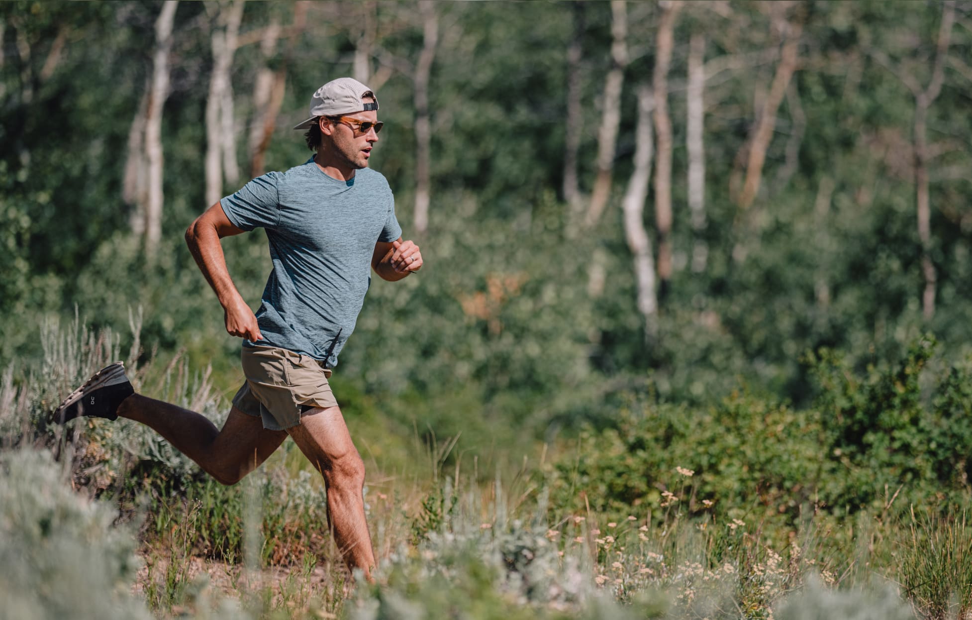 Man trail running wearing Mayfield sunglasses