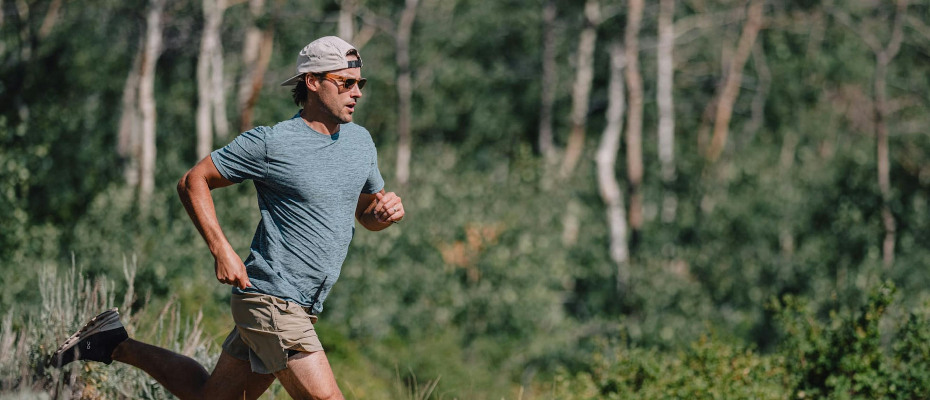 Man trail running outside wearing Mayfield sunglasses