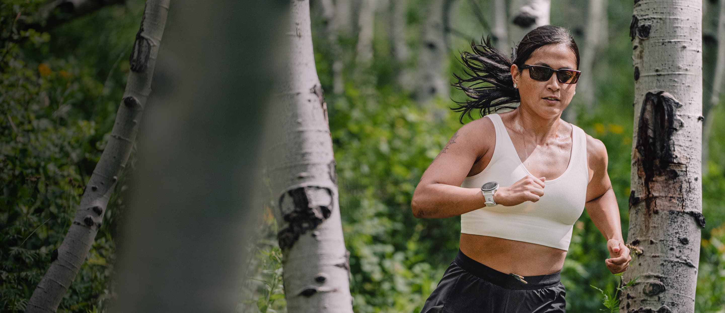 Woman trail running wearing Mayfield sunglasses