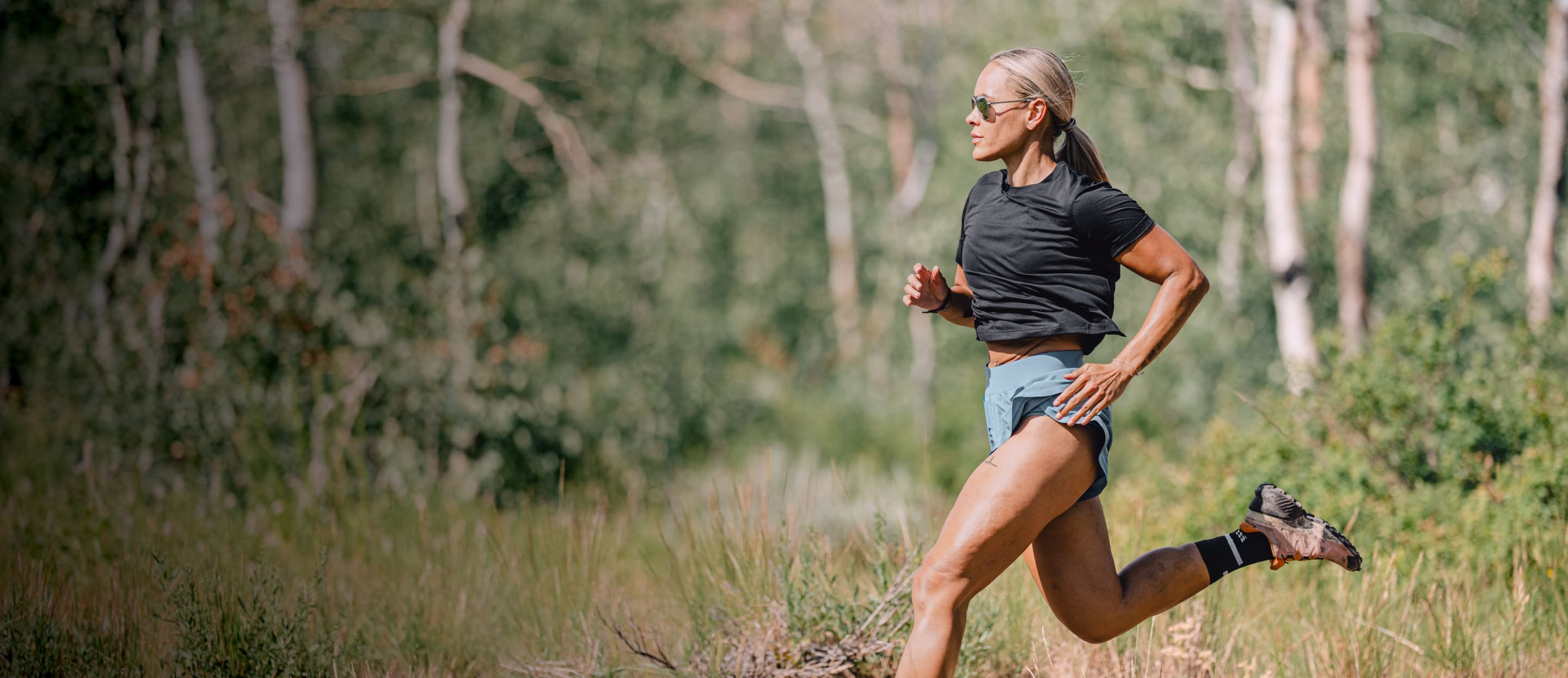 Woman trail running wearing Phantom sunglasses