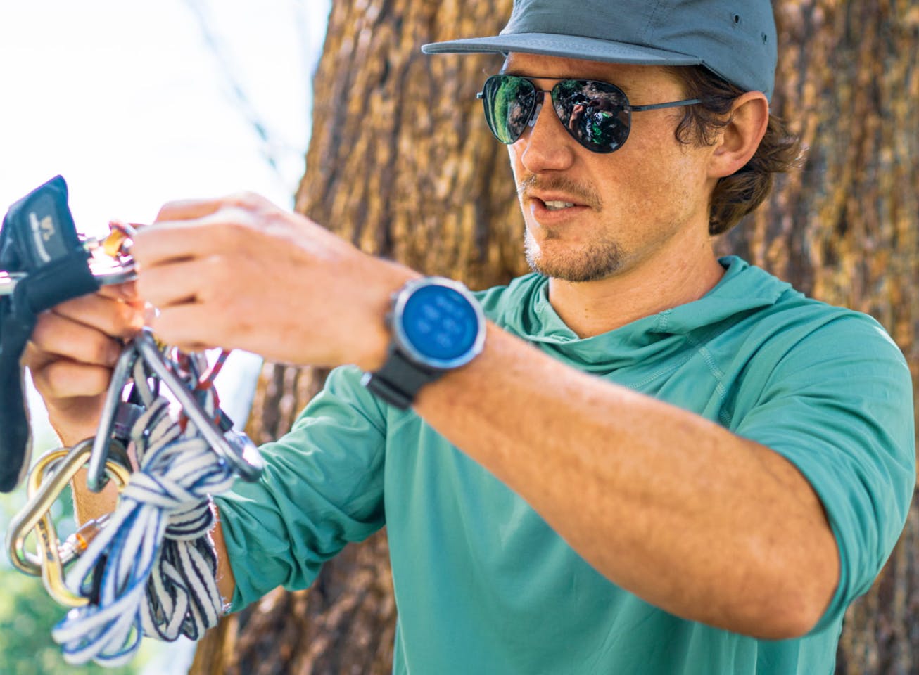 Man holding climbing gear wearing Phantom sunglasses