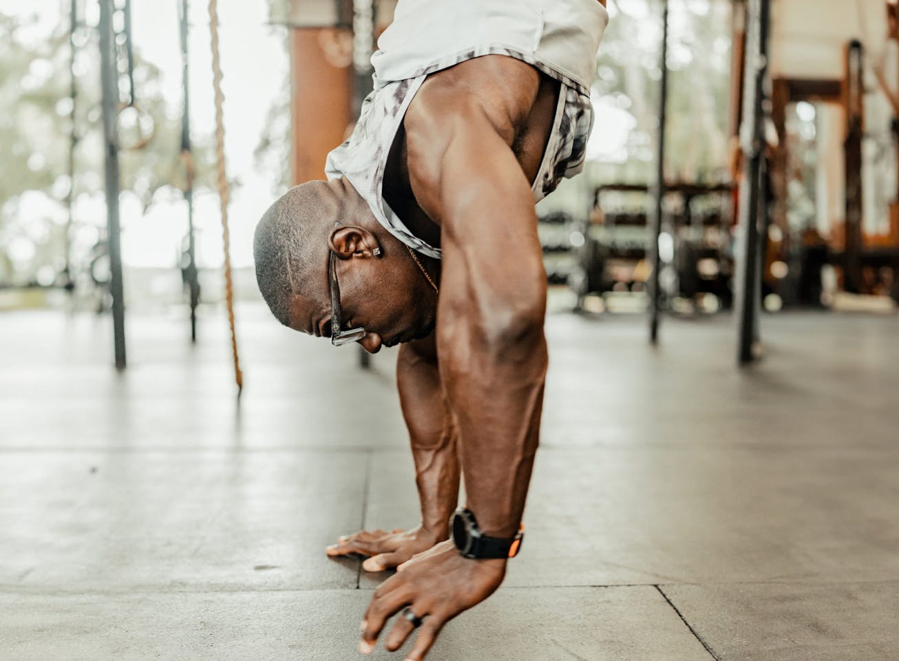 Man doing a hand stand wearing Barton eyeglasses