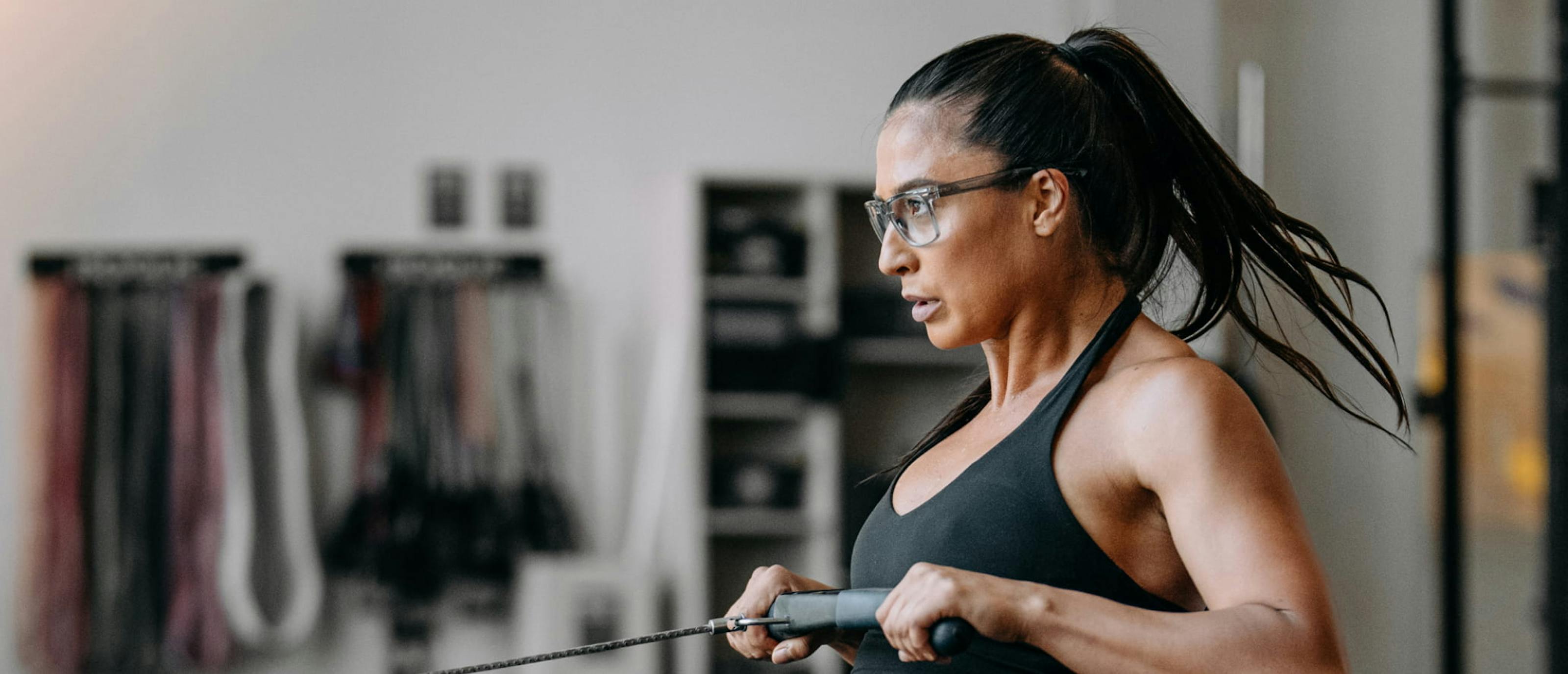 Woman on rowing machine wearing Barton eyeglasses
