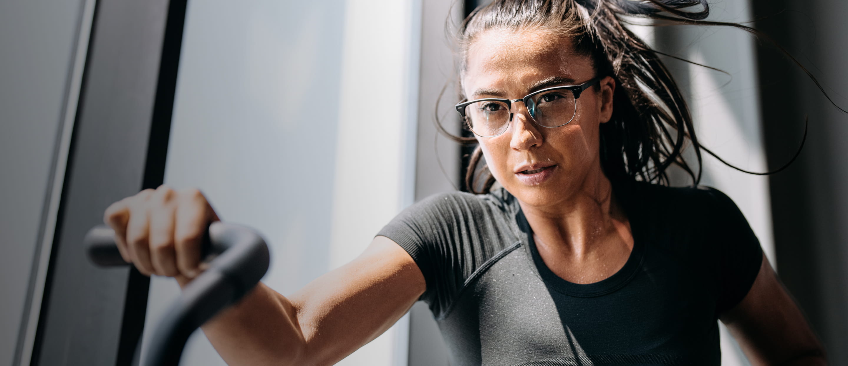 Woman working out in gym wearing Cambridge eyeglasses