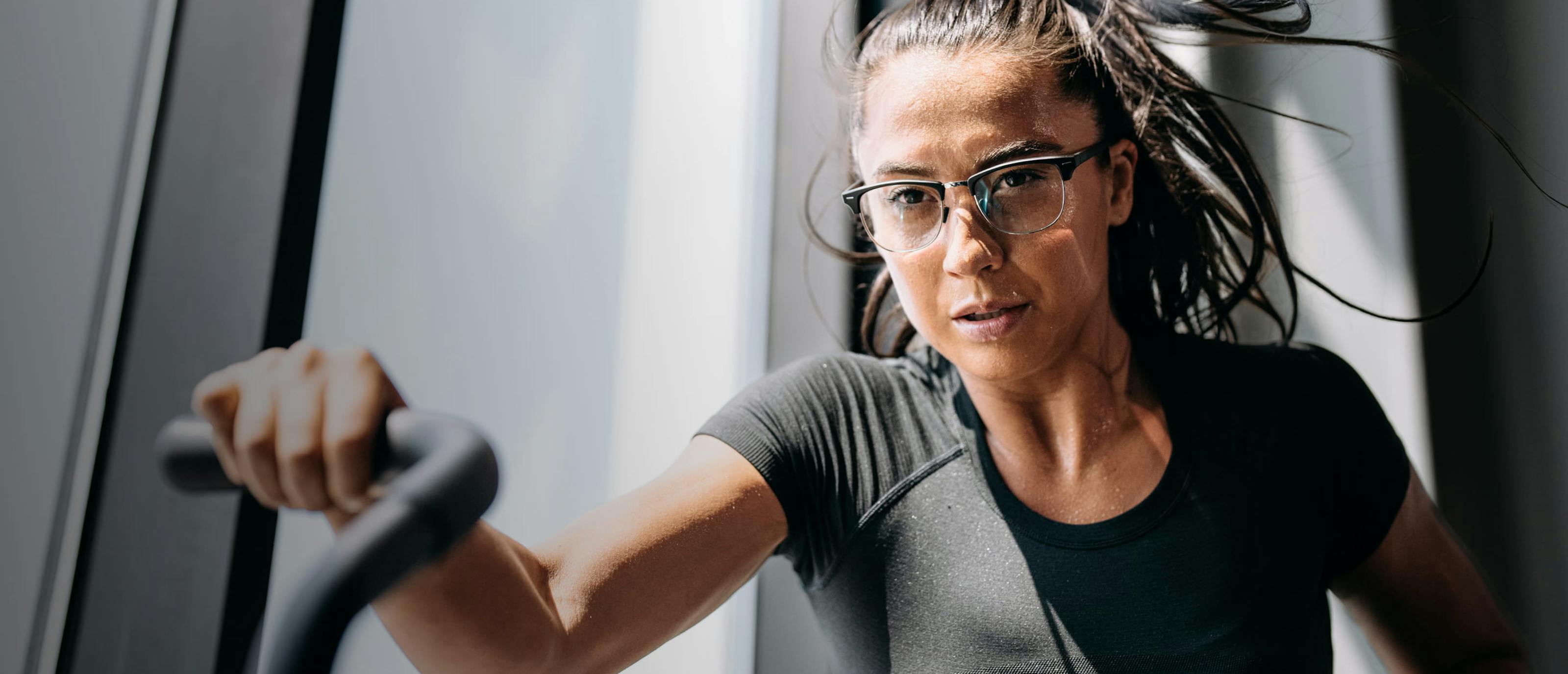 Woman working out in gym wearing Cambridge eyeglasses