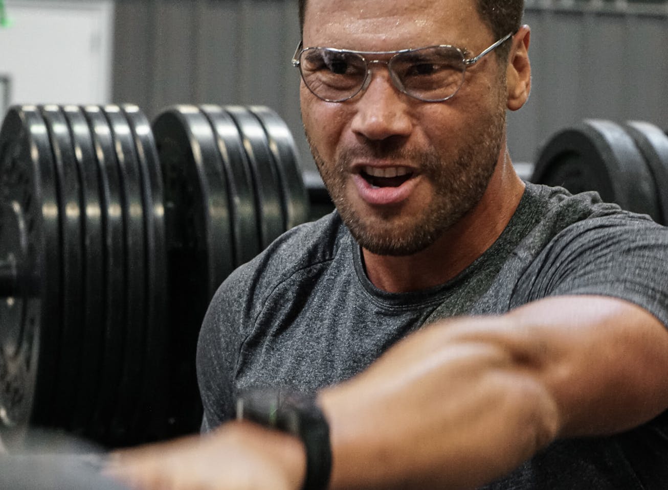 Man doing kettlebell exercise in gym wearing Rio eyeglasses