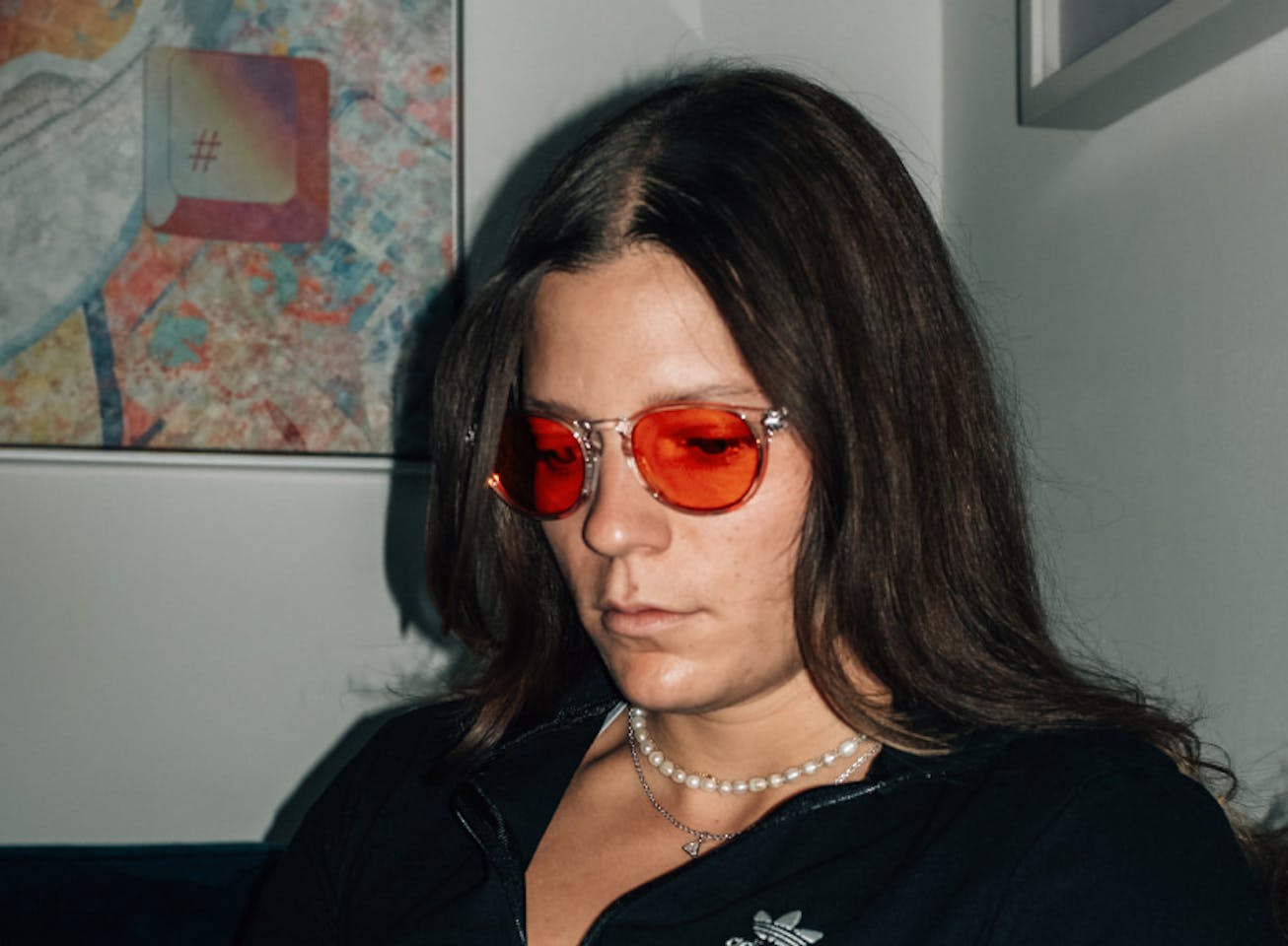 Woman wearing black jacket and Red Lens glasses
