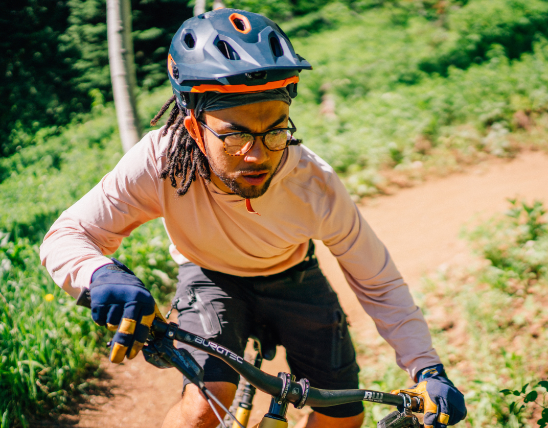 Man riding bike wearing square, matte black/campfire tortoise Hunter eyeglasses