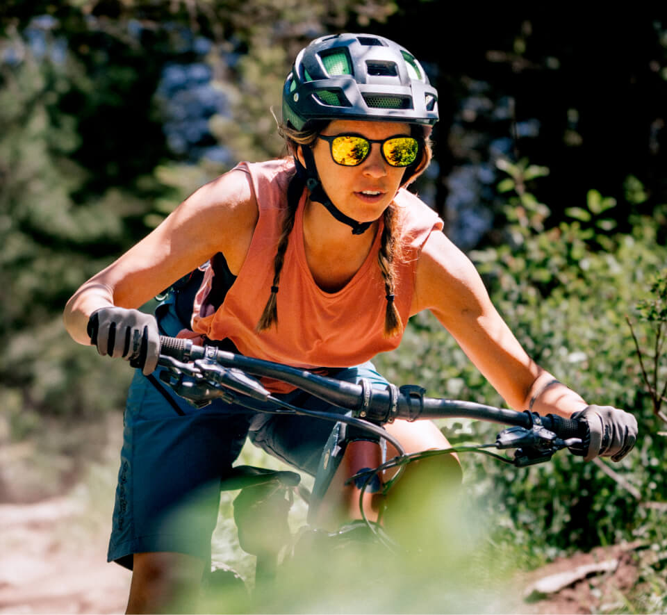 Woman riding mountain bike in Rory Sunglasses 