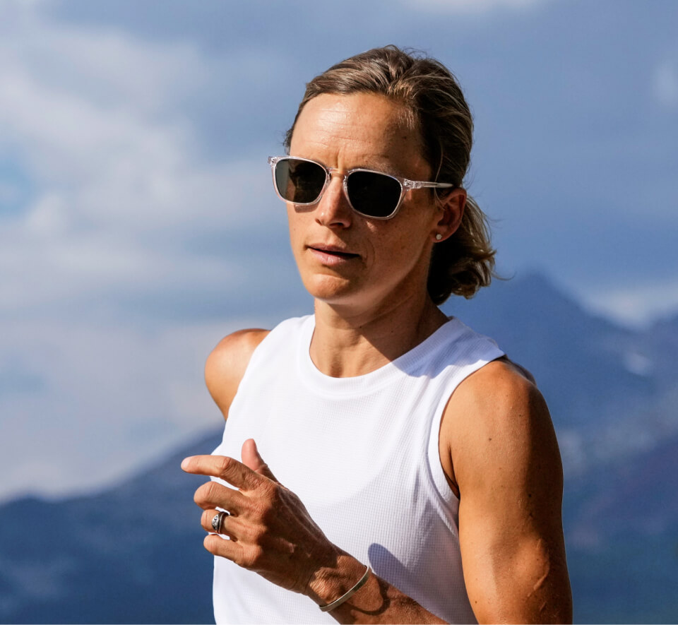 Woman jogging in the mountains wearing Rory sunglasses
