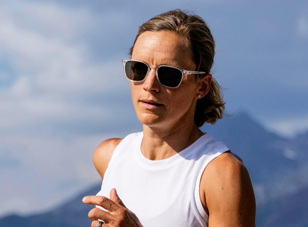 Woman jogging in the mountains wearing Rory sunglasses
