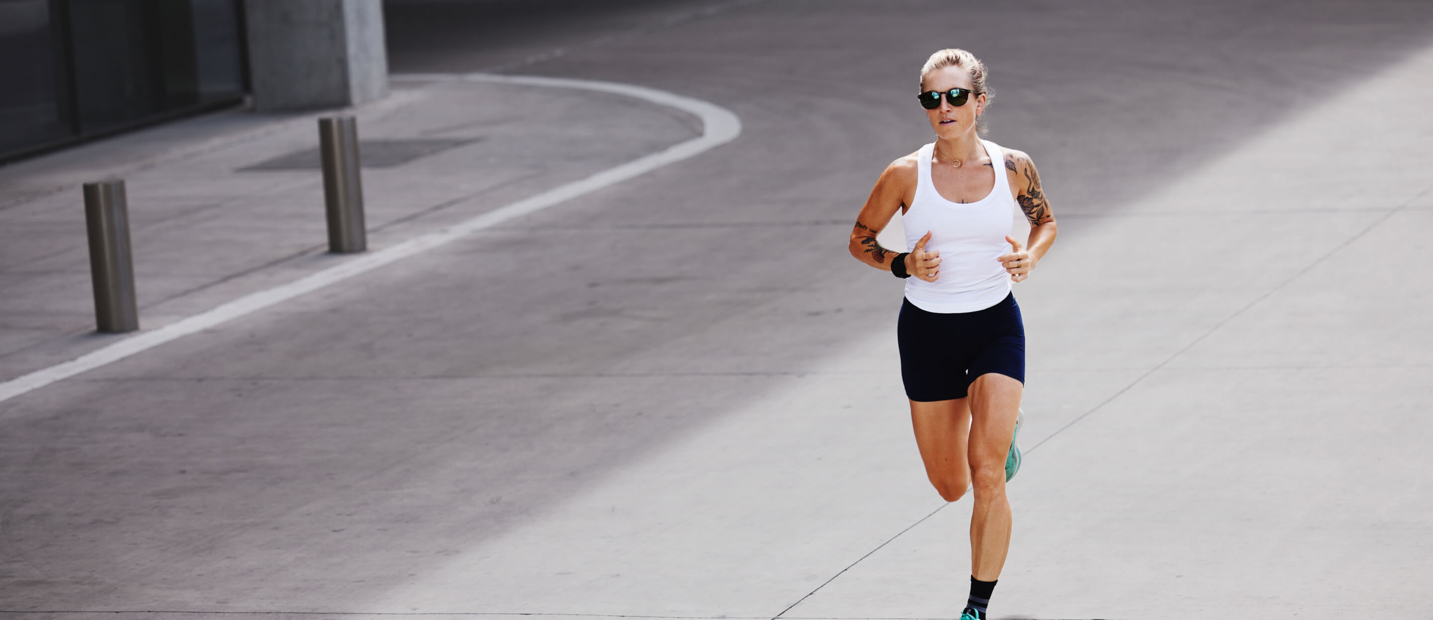 Woman in white tank top running
