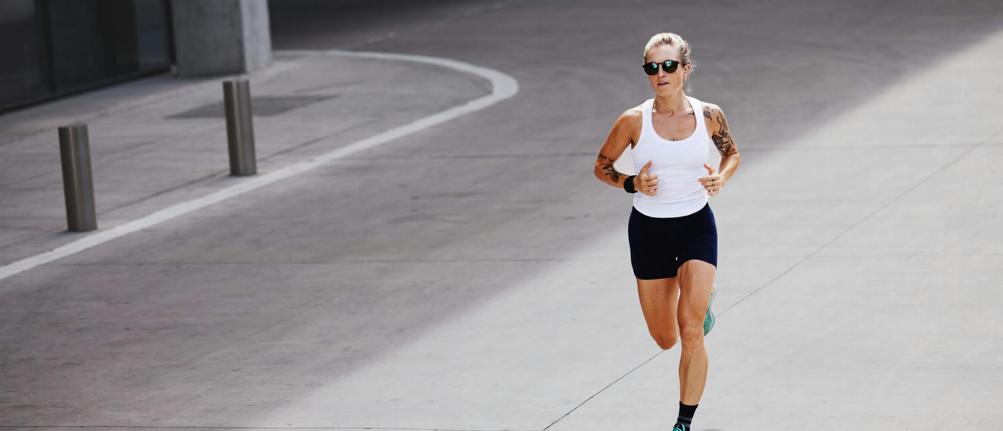 Woman in white tank top running