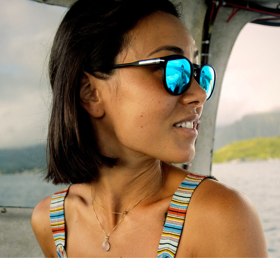 Woman in rainbow tank top and Oslo Sunglasses