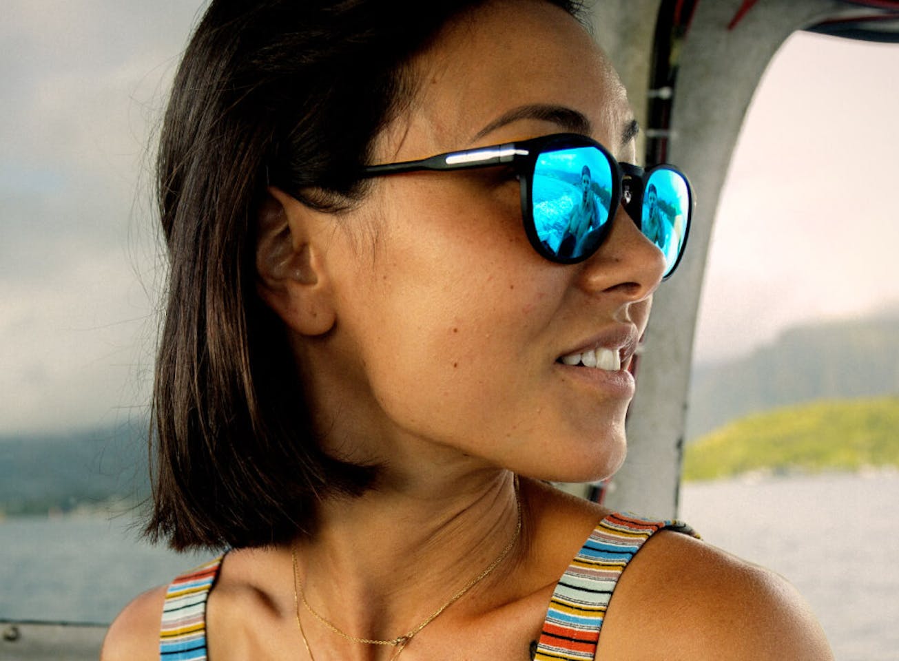 Woman in rainbow tank top and Oslo Sunglasses