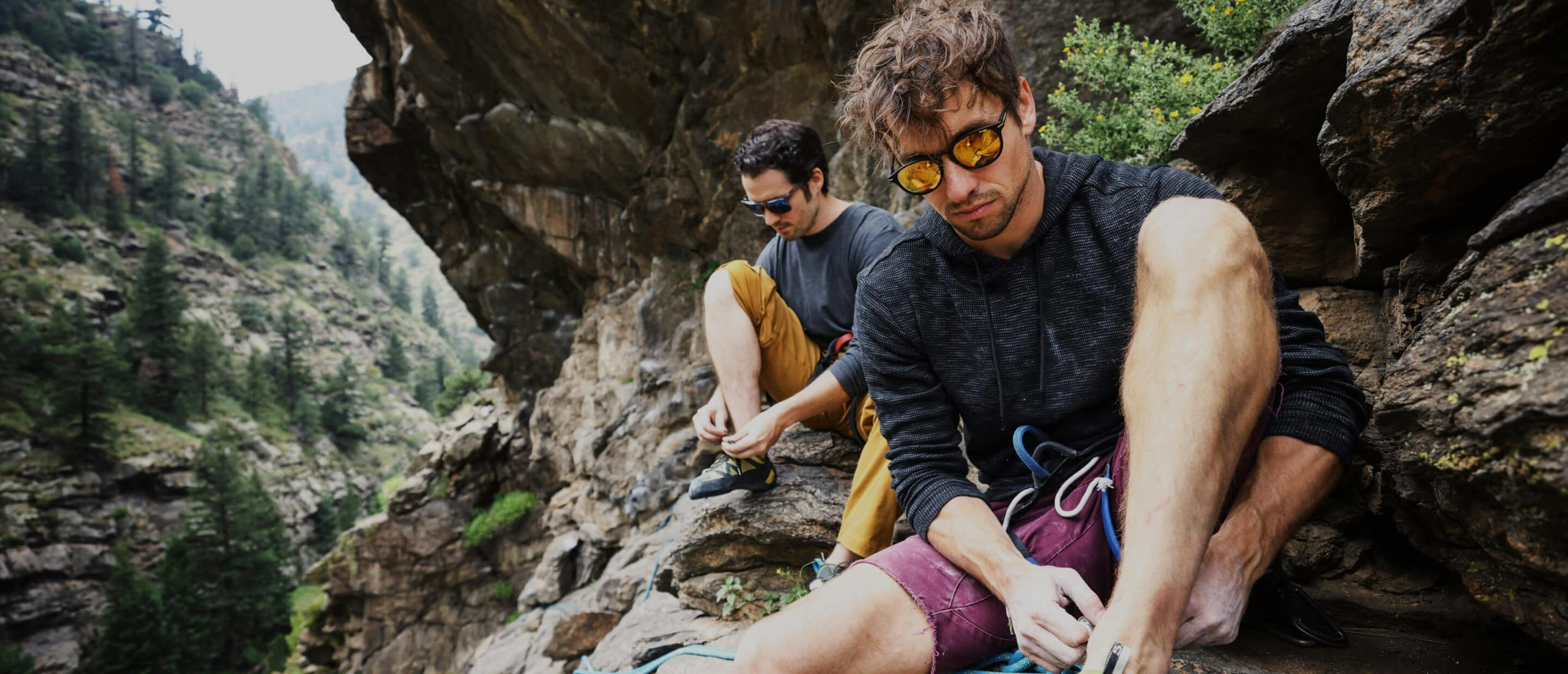 Man putting on rock climbing shoes