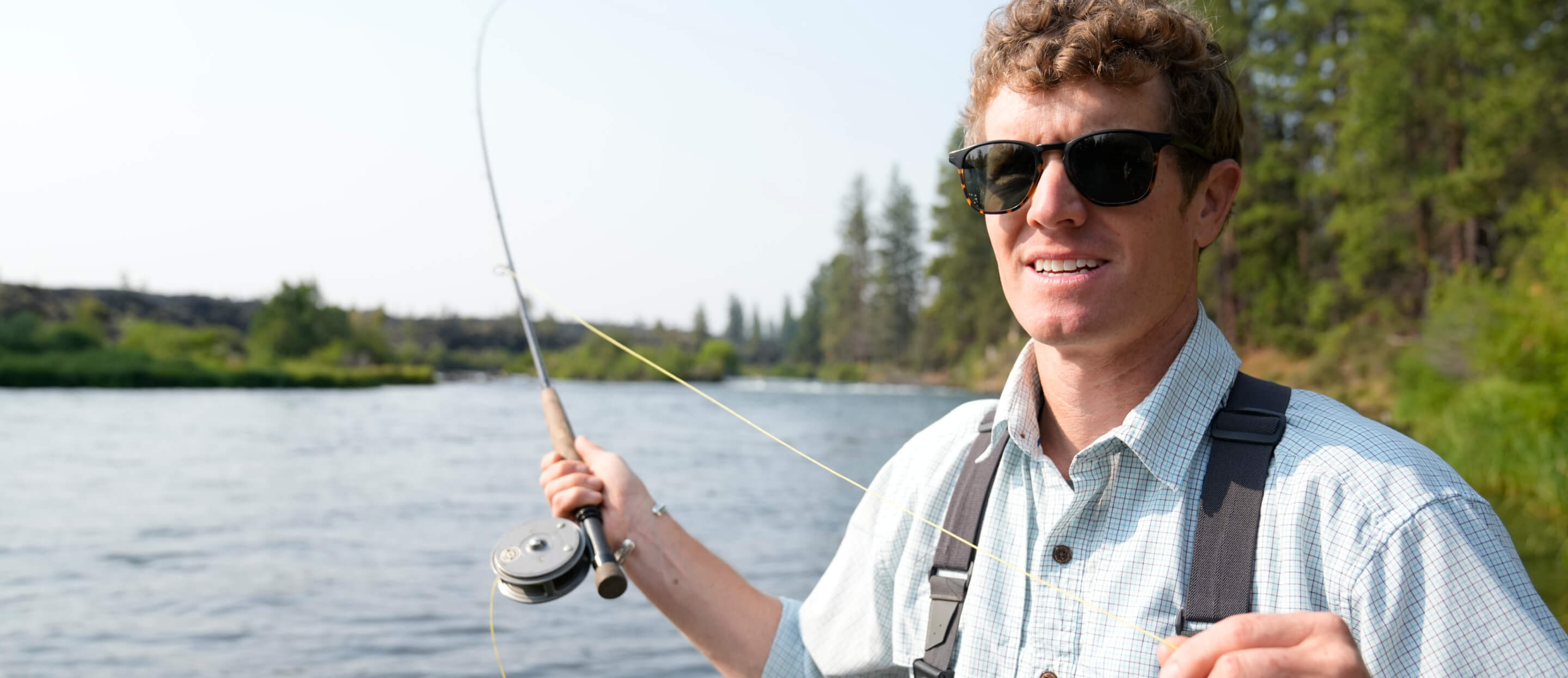 Man casting fishing rod in river