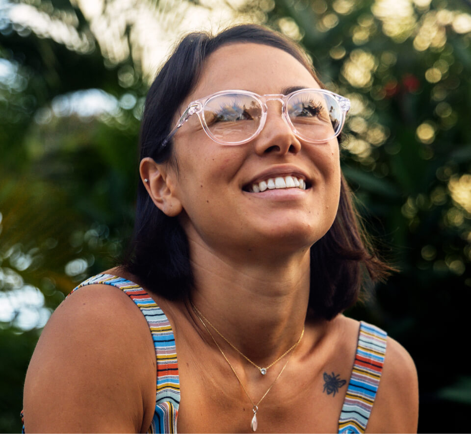 Woman smiling in rainbow rank top and Oslo eyeglasses