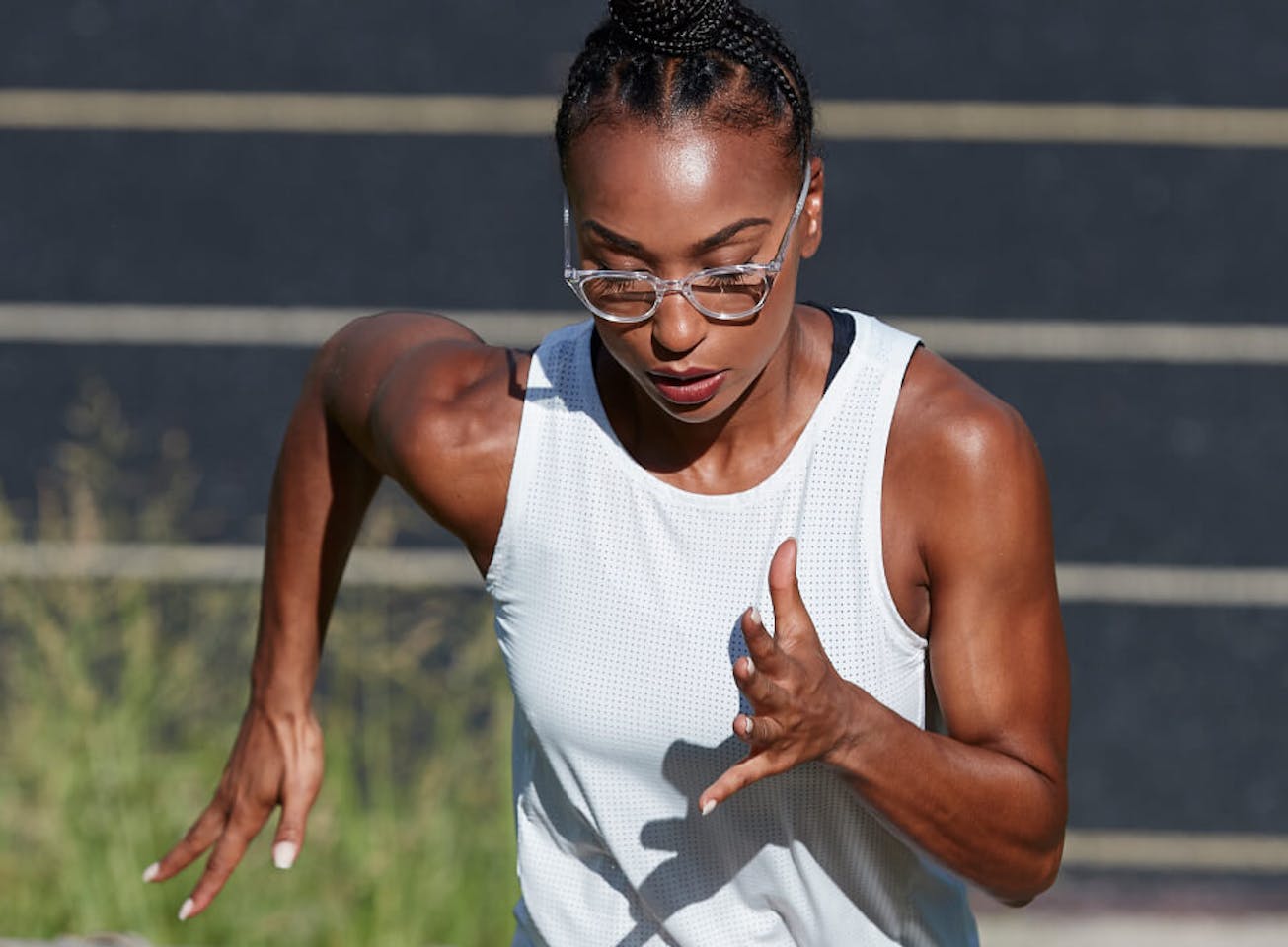 Woman running near track in Lola eyeglases