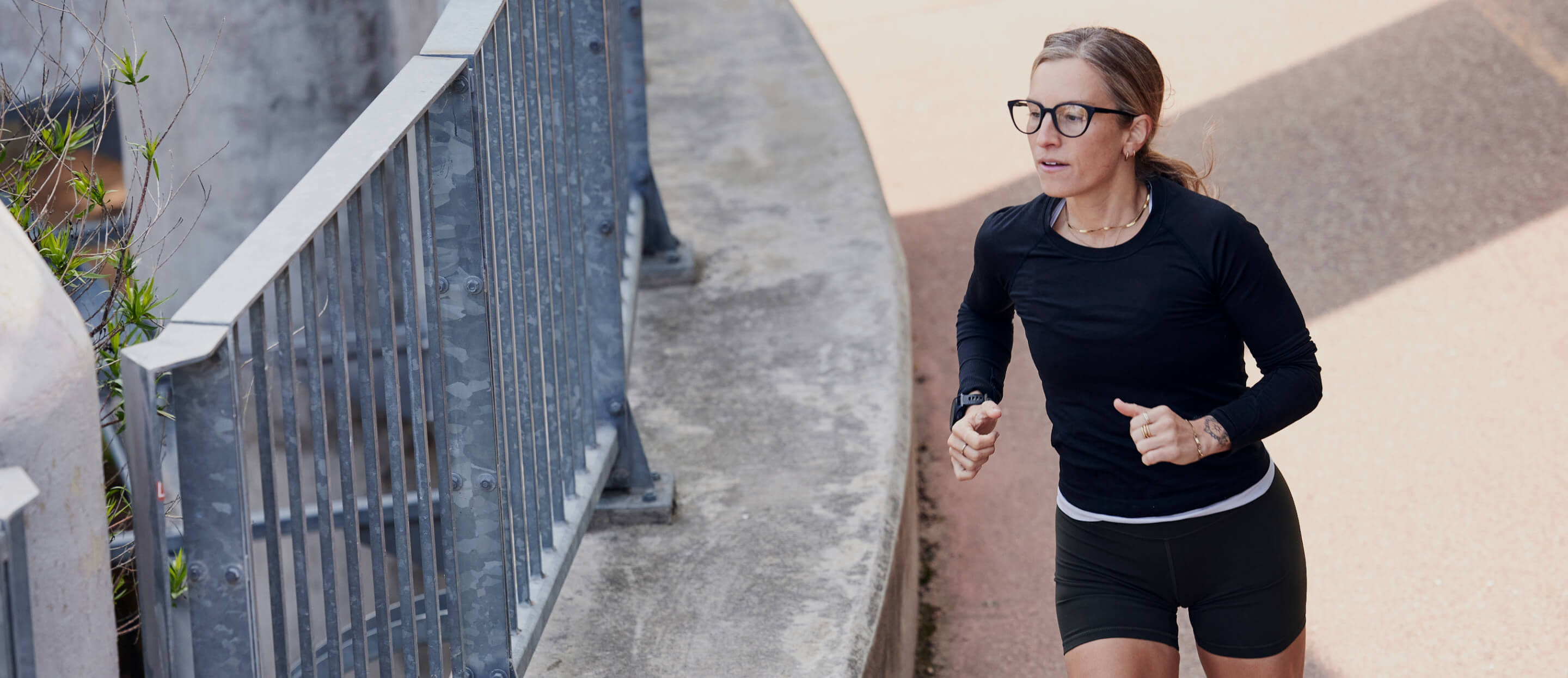 Woman jogging in black top in Lola Eyeglasses