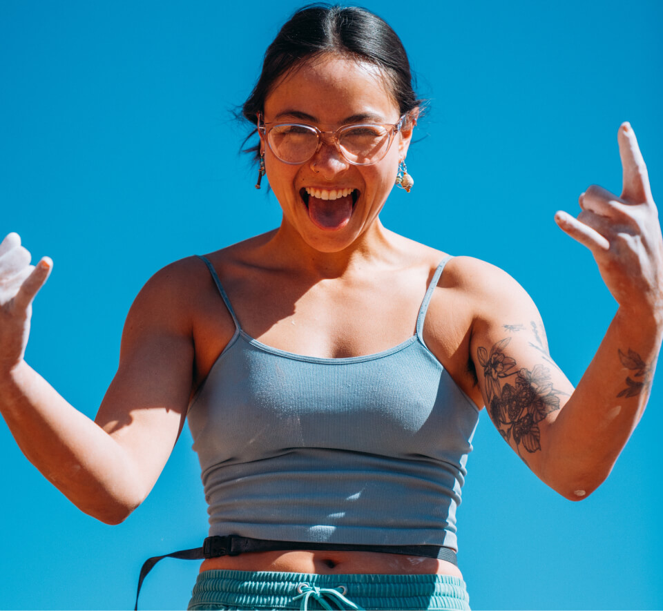 Woman smiling with tongue out in Lola eyeglasses