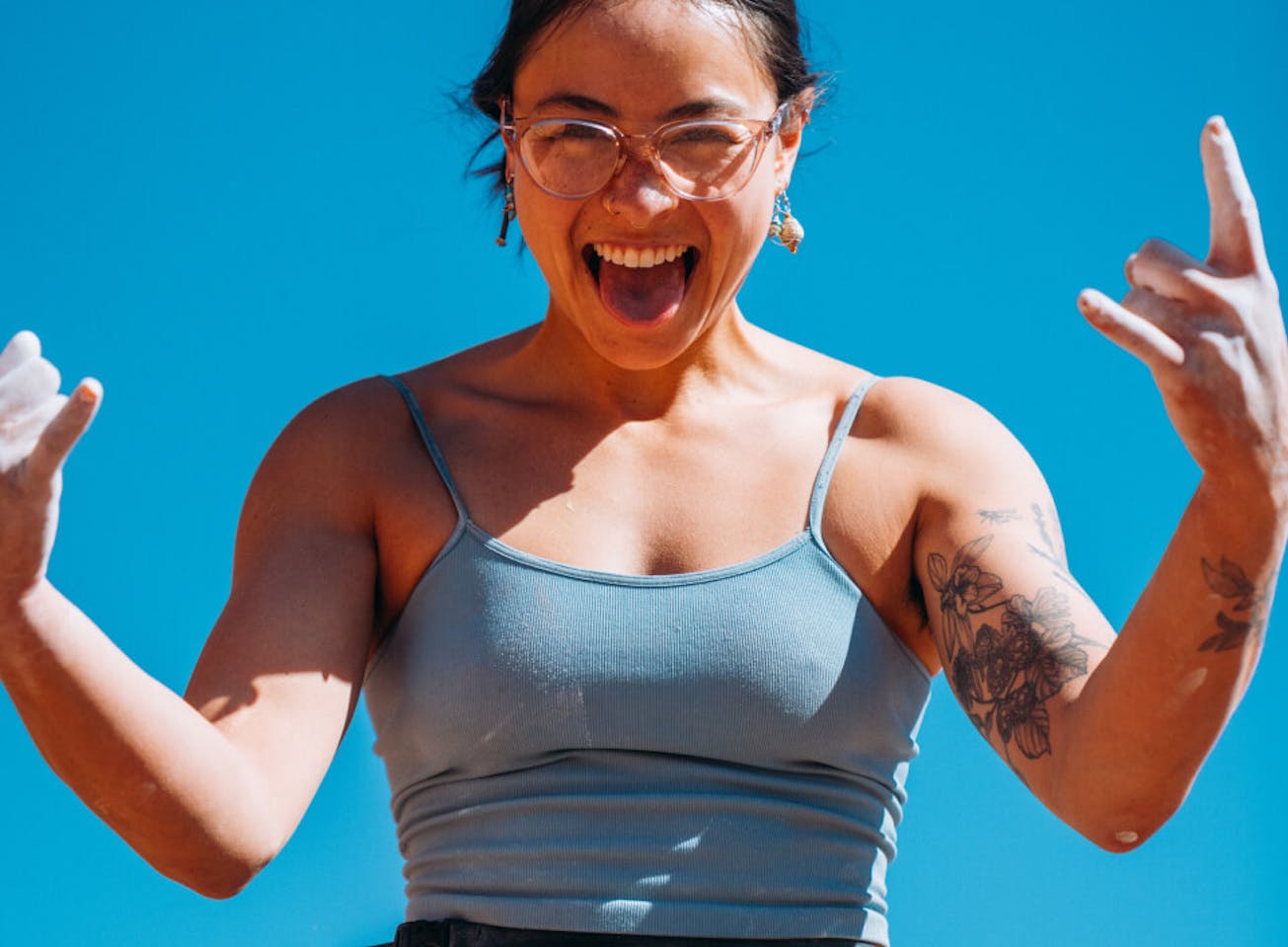 Woman smiling with tongue out in Lola eyeglasses