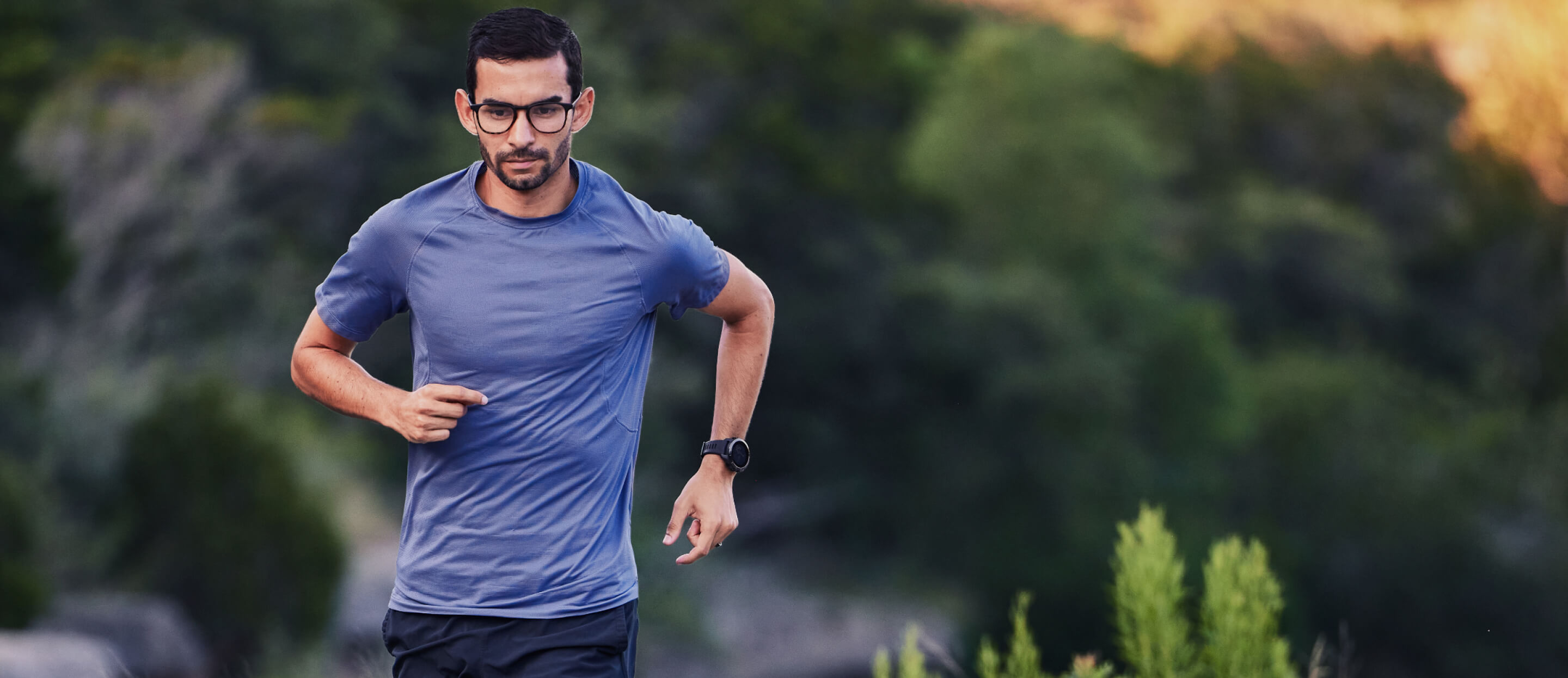 Man in blue shirt jogging in Hunter Eyeglasses