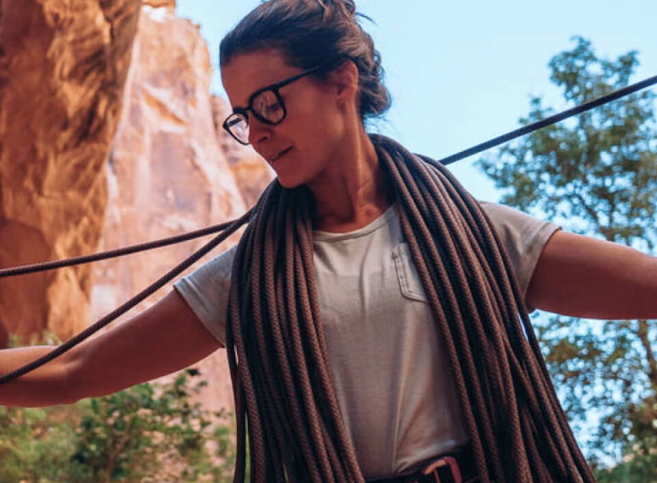Woman organizing rock climbing rope wearing Hunter eyeglasses