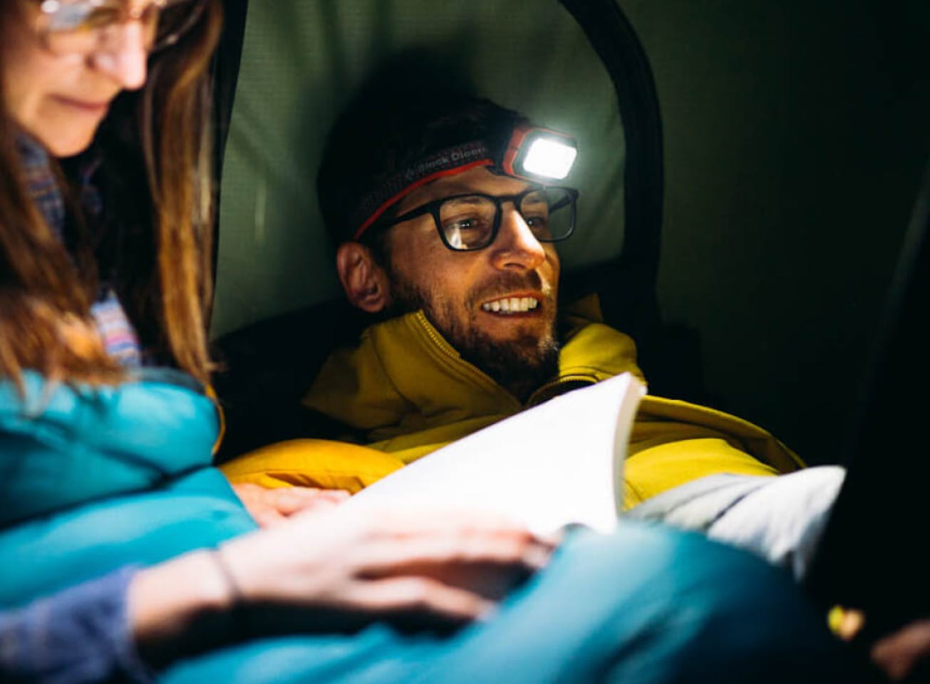Man using headlamp in camping tent wearing Rory eyeglasses
